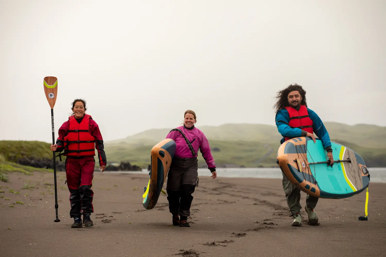 Guests of Adak Island Inn preparing to stand-up paddle board in Adak, Alaska
